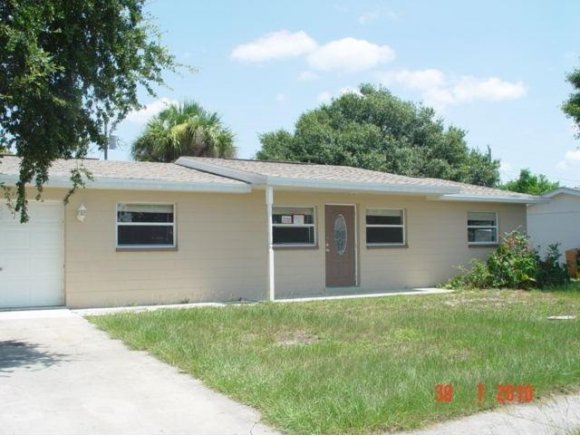 2430 Lisa Melbourne, FL 32935 - Photo 1 of 11 a front view of house with yard and green space