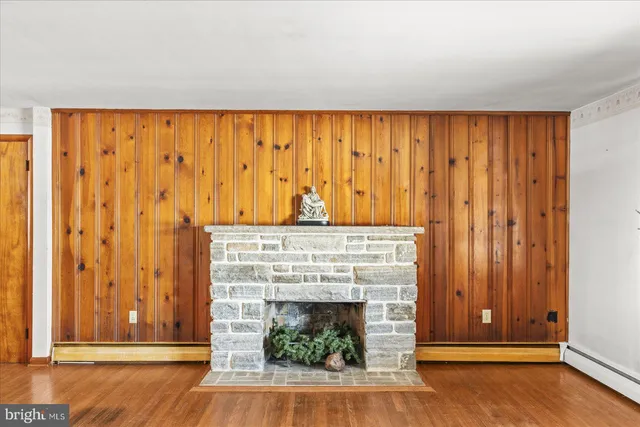 a living room with a fireplace and a wooden floor