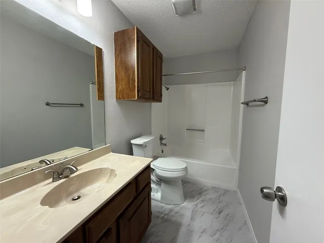 a bathroom with a sink toilet and mirror