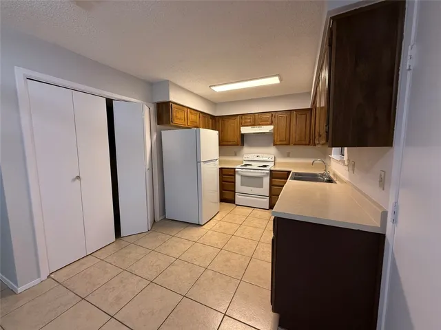 a kitchen with stainless steel appliances a refrigerator sink and microwave