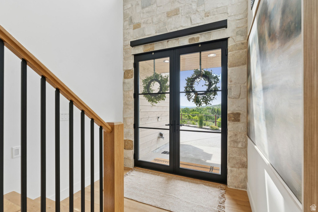 1400 Weber Wild Road Oakley, UT 84055 - Photo 8 of 55 Double black-framed glass entry doors with transom, set within a natural stone wall