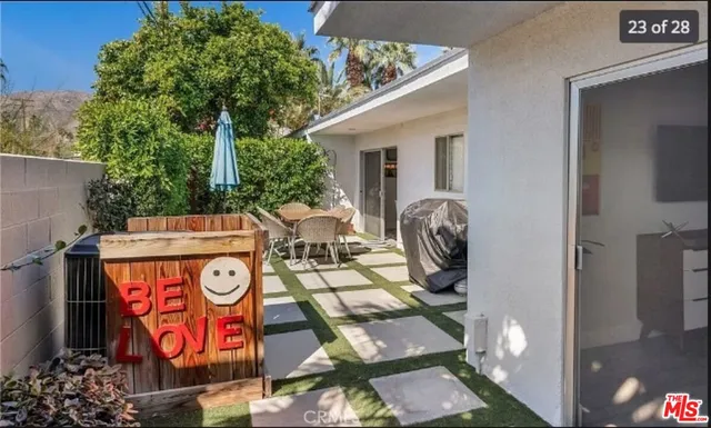 a table with chairs and a potted plant