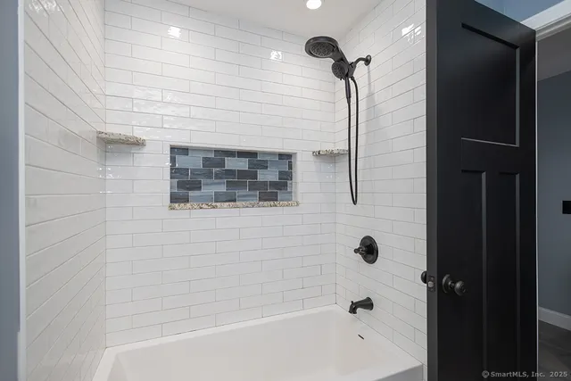 a bathroom with a bathtub and shower