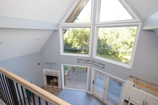 a living room with a fireplace and a window