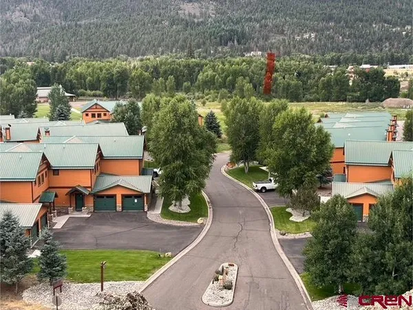 an aerial view of a house with a yard basket ball court and outdoor seating