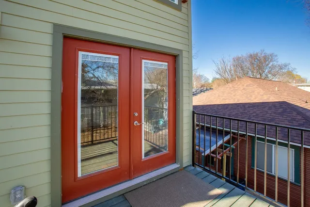 a view of a balcony with a door and wooden floor