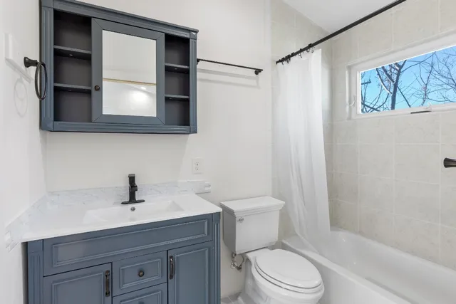 a bathroom with a sink toilet a mirror and shower