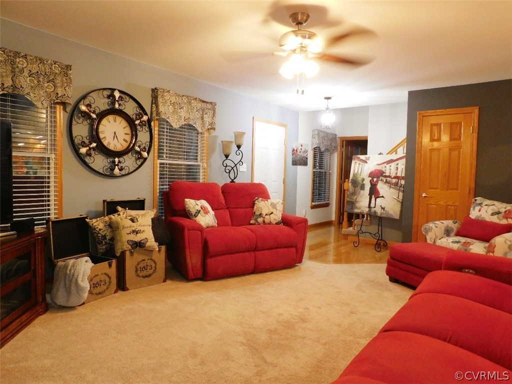 720 Putney Road Farmville, VA 23901 - Photo 9 of 33 a living room with furniture a clock on wall and a chandelier