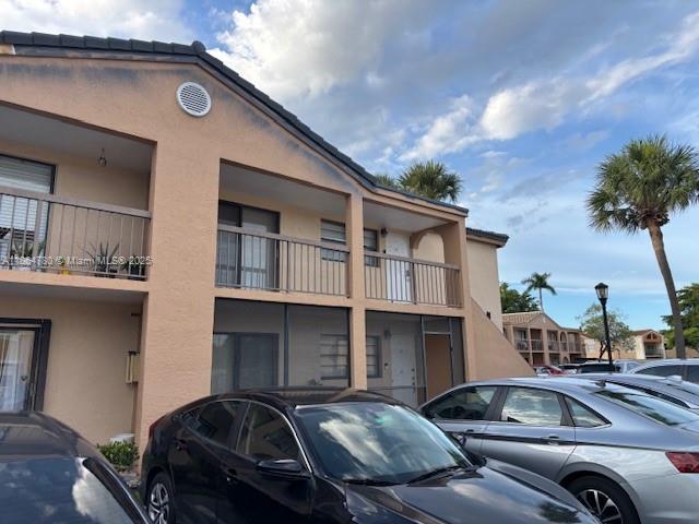 18280 Mediterranean Boulevard, Unit 23 Hialeah, FL 33015 - Photo 1 of 2 a couple of cars parked in front of a house
