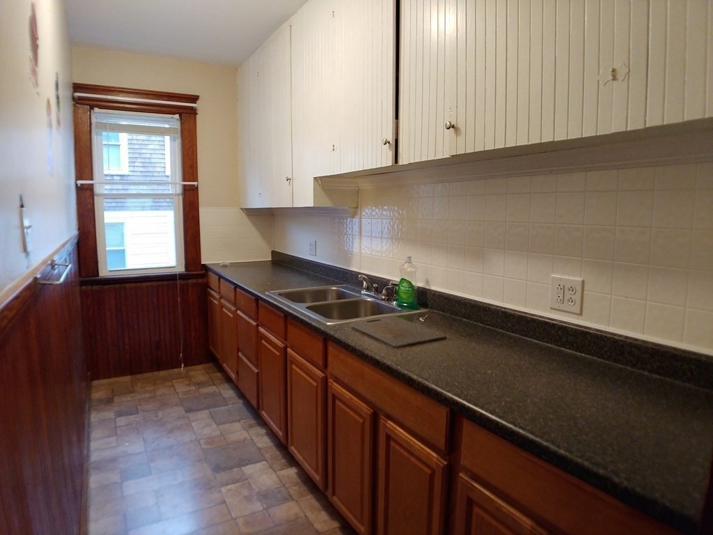 20 Wabash Avenue Worcester, MA 01604 - Photo 8 of 26 a kitchen with granite countertop a sink a stove and cabinets