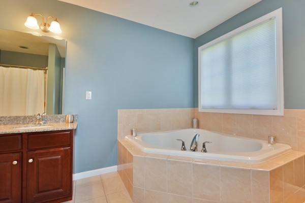 7 John Riley Road Ayer, MA 01432 - Photo 20 of 29 a bathroom with a bathtub and a sink