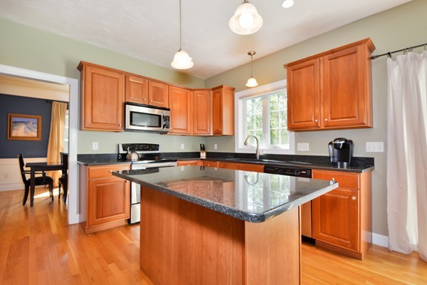 7 John Riley Road Ayer, MA 01432 - Photo 8 of 29 a kitchen with stainless steel appliances granite countertop a stove a sink dishwasher a microwave oven with granite countertops and cabinets