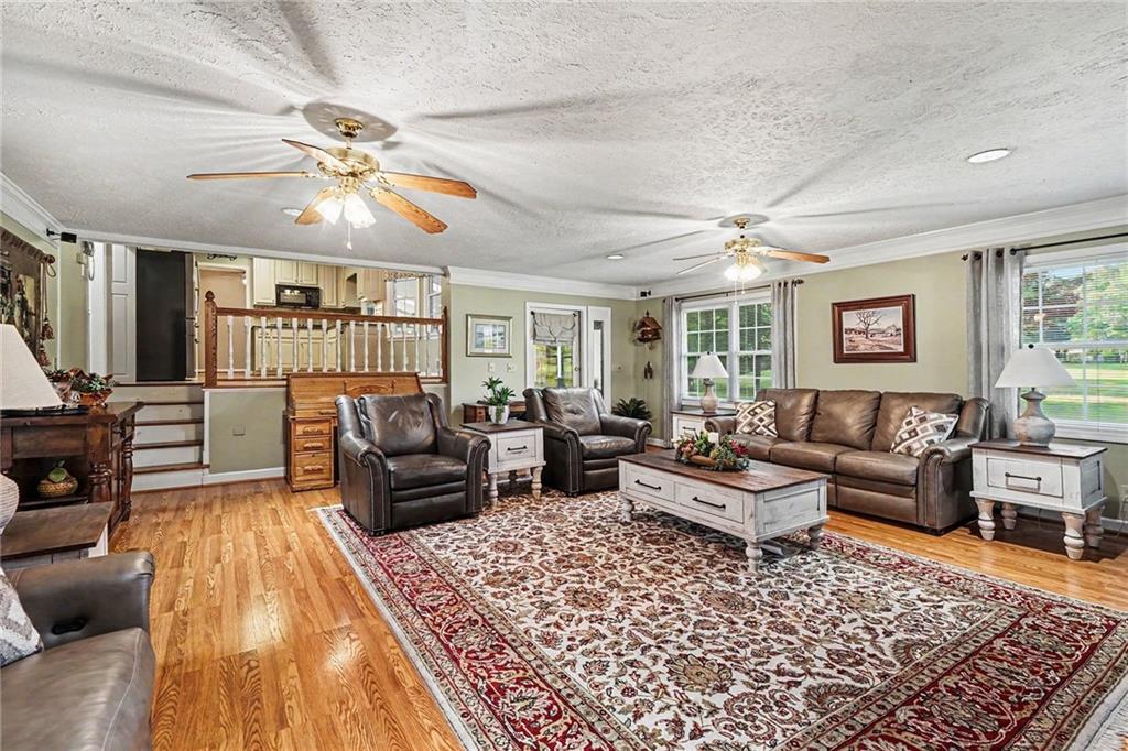 740 Smyrna Road Southwest Conyers, GA 30094 - Photo 5 of 27 a living room with furniture and wooden floor