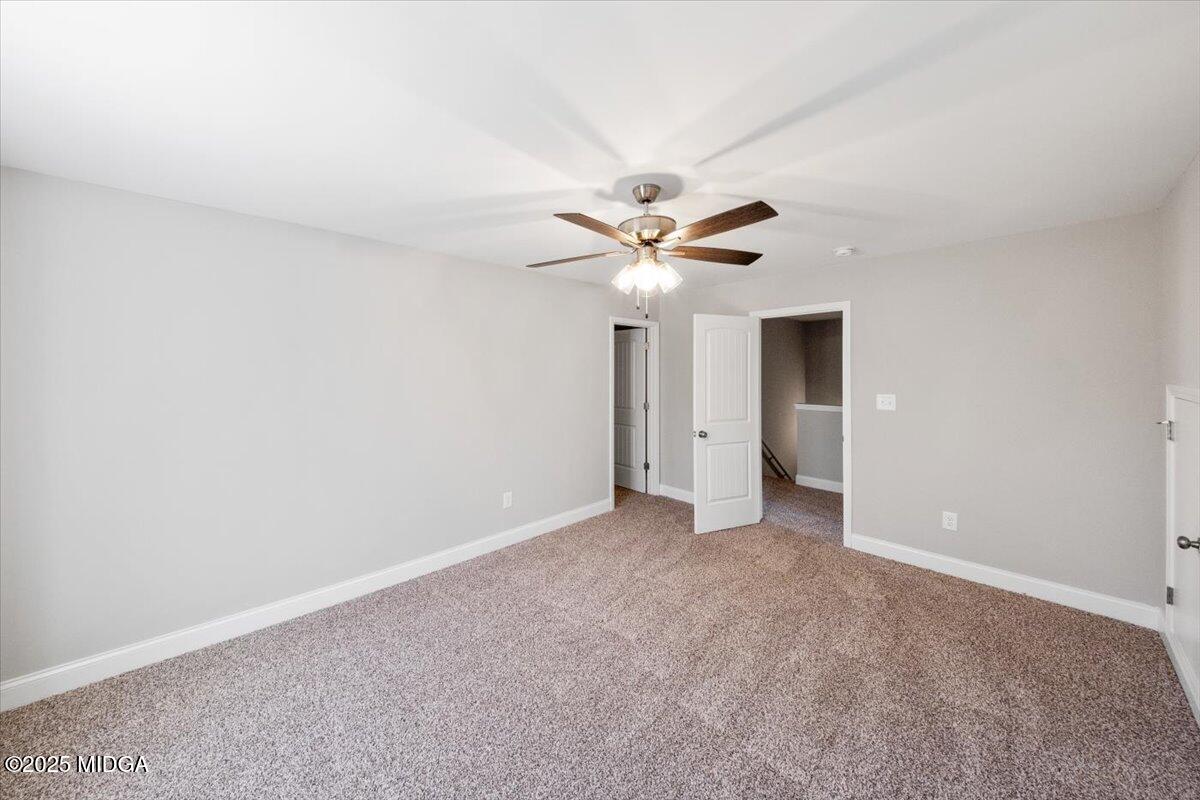 372 Walnut Grove Road Gray, GA 31032 - Photo 16 of 21 an empty room with a ceiling fan and a window