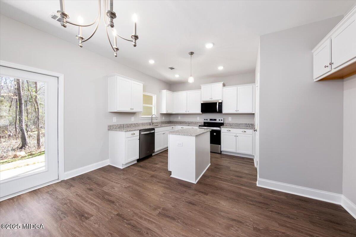 372 Walnut Grove Road Gray, GA 31032 - Photo 5 of 21 a kitchen with a refrigerator a stove top oven and wooden floor