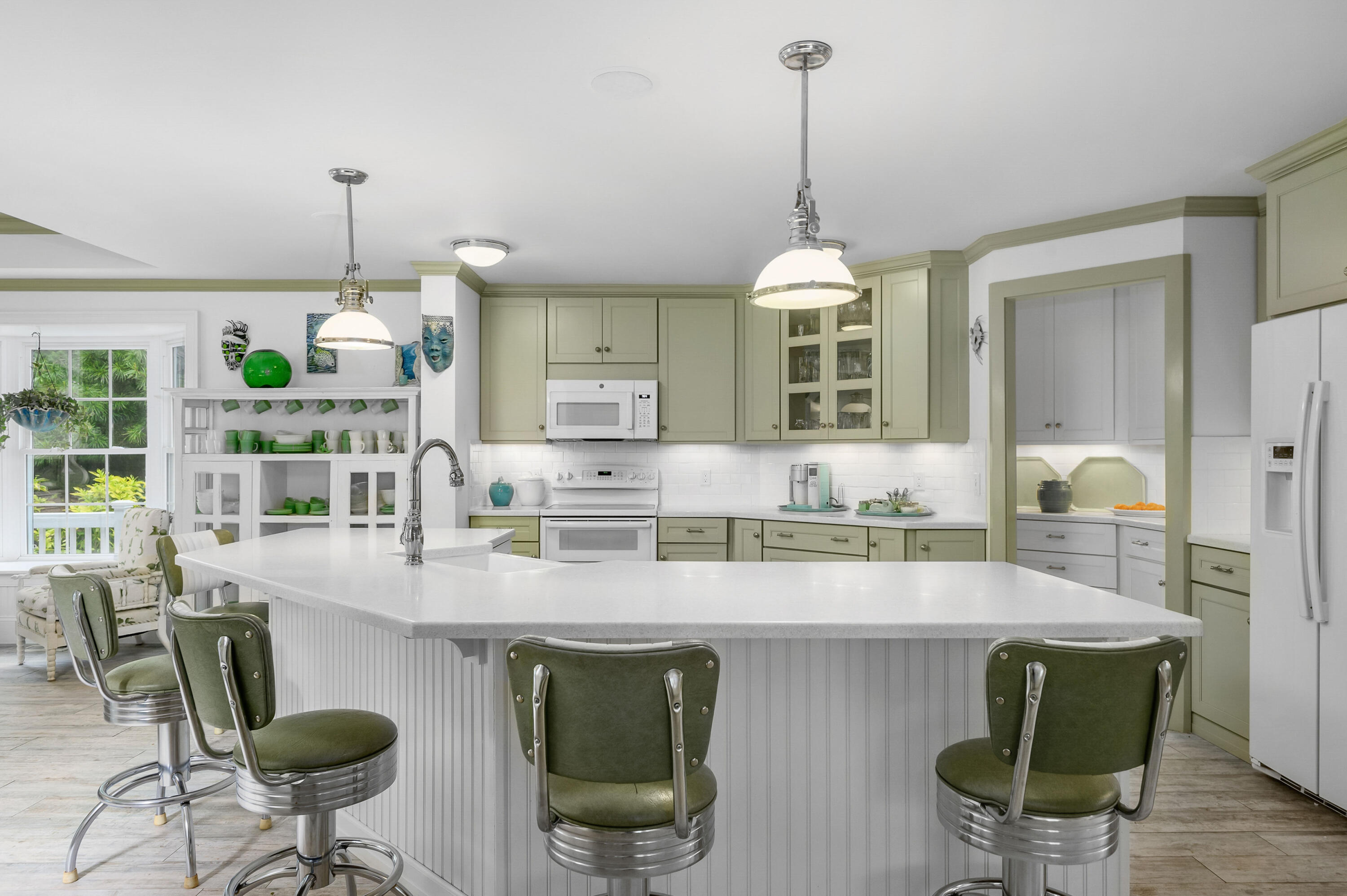 256 Pleasant Bay Road Harwich, MA 02645 - Photo 17 of 71 a kitchen with granite countertop a dining table chairs and white cabinets