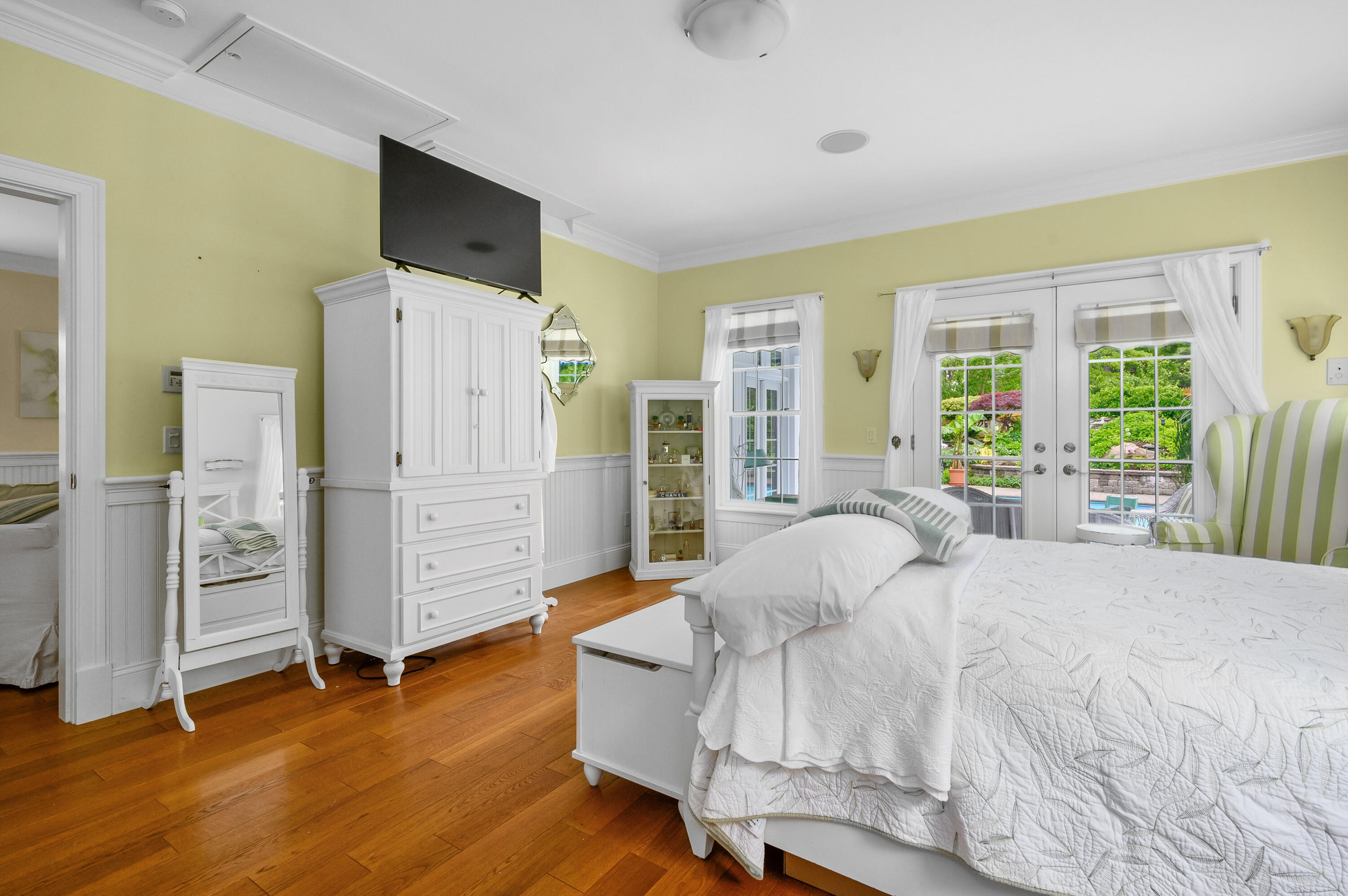 256 Pleasant Bay Road Harwich, MA 02645 - Photo 21 of 71 a spacious bedroom with a bed and wooden floor