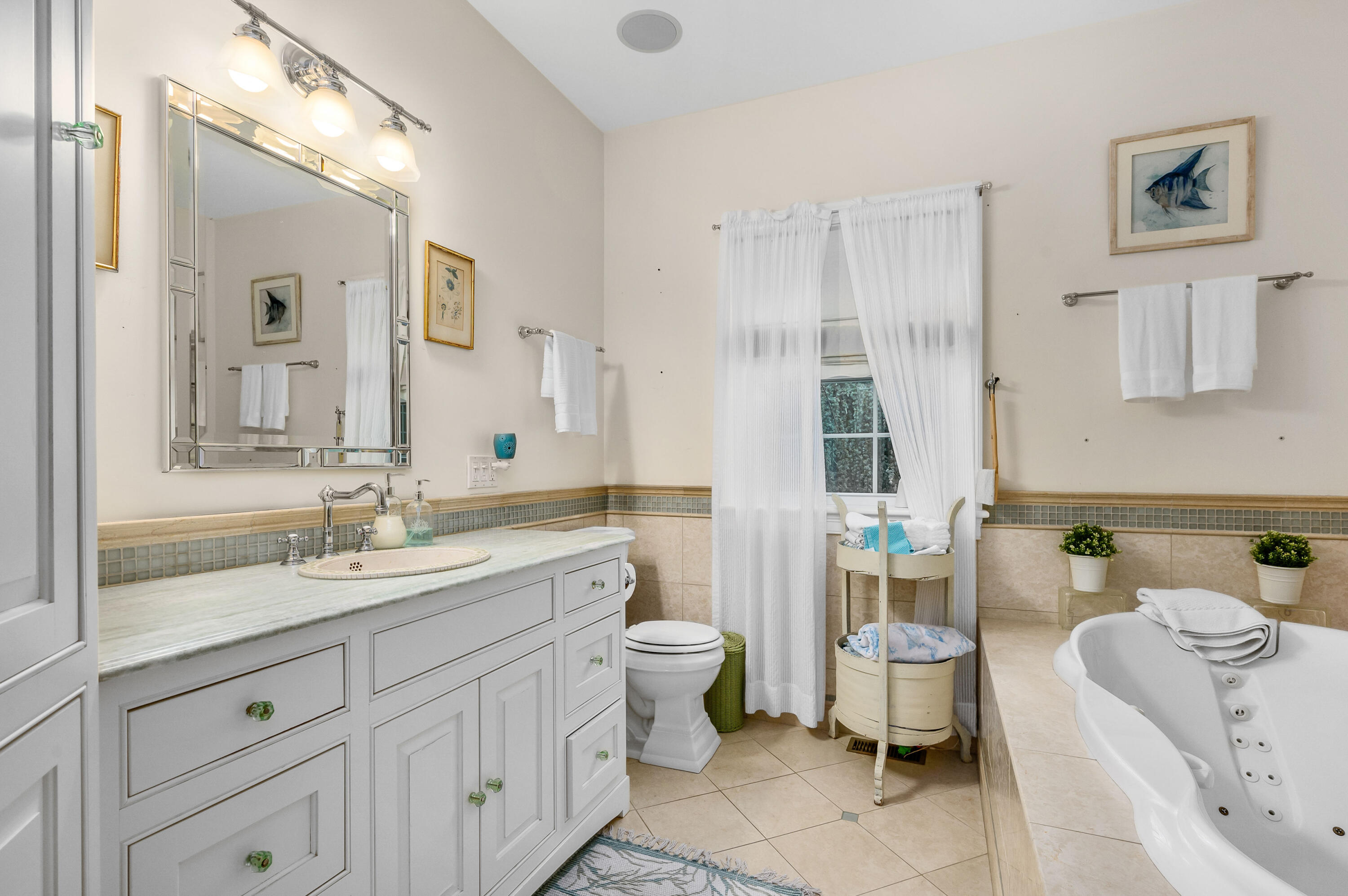 256 Pleasant Bay Road Harwich, MA 02645 - Photo 22 of 71 a bathroom with a double vanity sink mirror and toilet