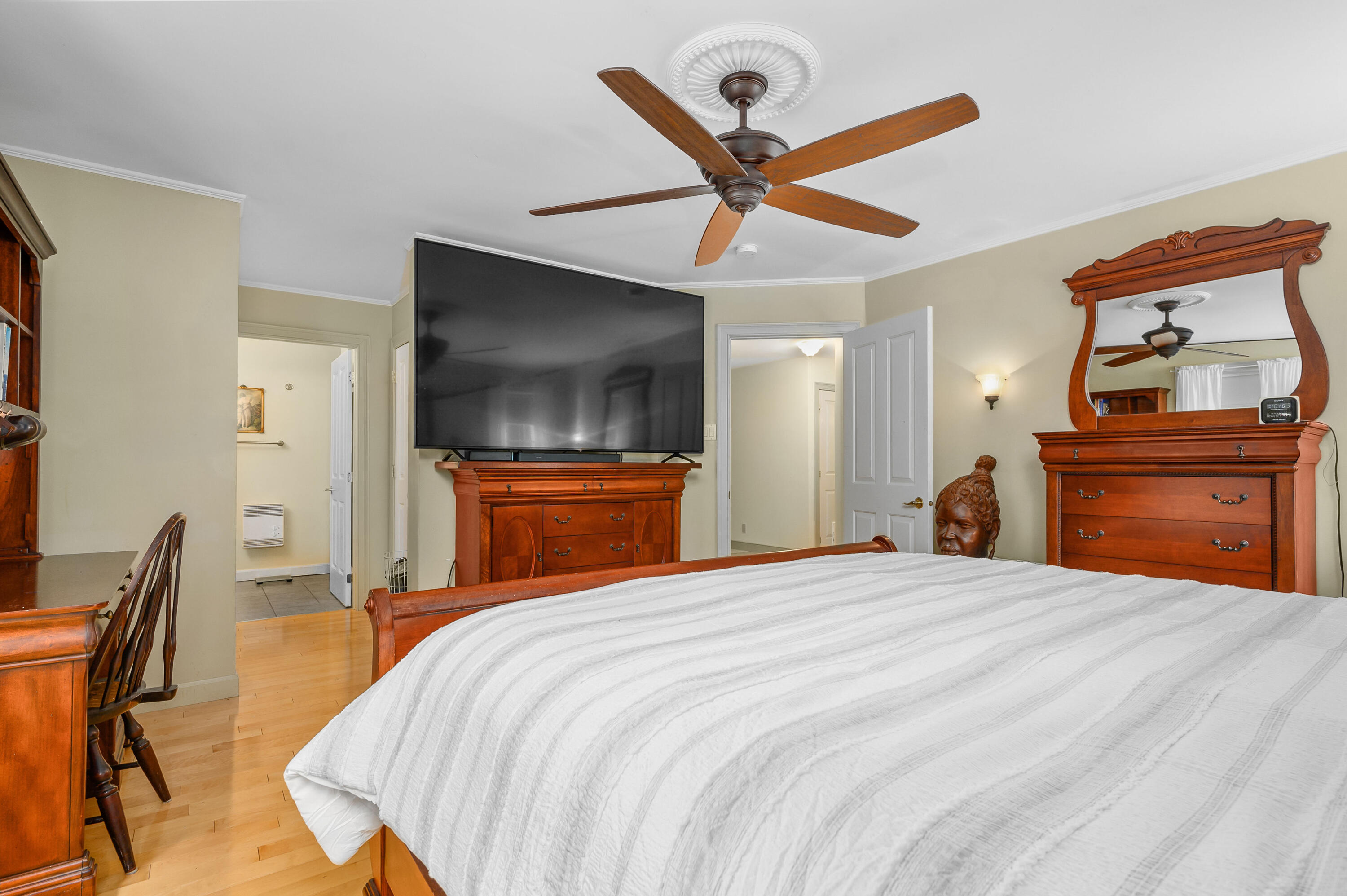256 Pleasant Bay Road Harwich, MA 02645 - Photo 29 of 71 a bedroom with a bed and a chandelier