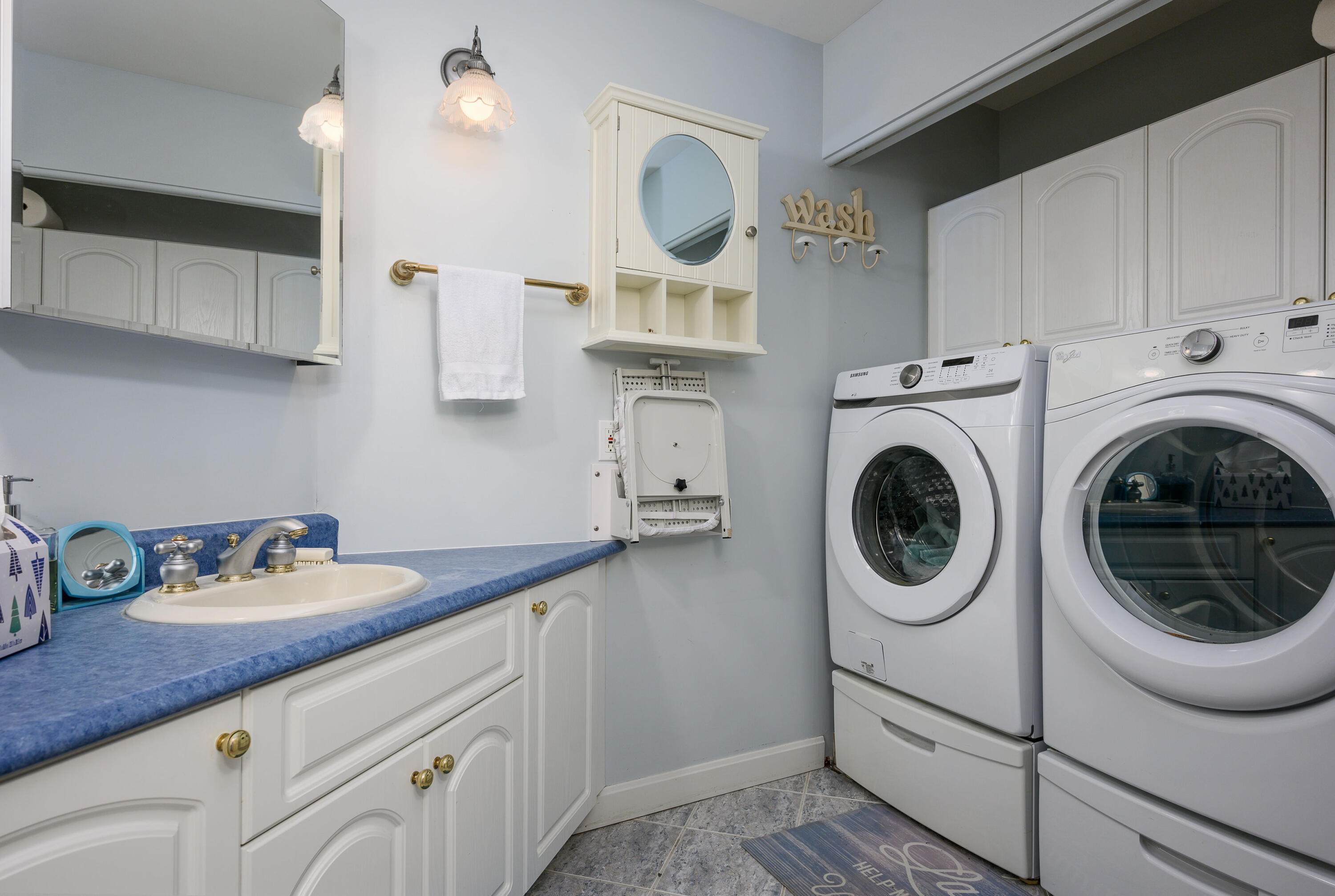 256 Pleasant Bay Road Harwich, MA 02645 - Photo 31 of 71 a kitchen with sink cabinets and washer