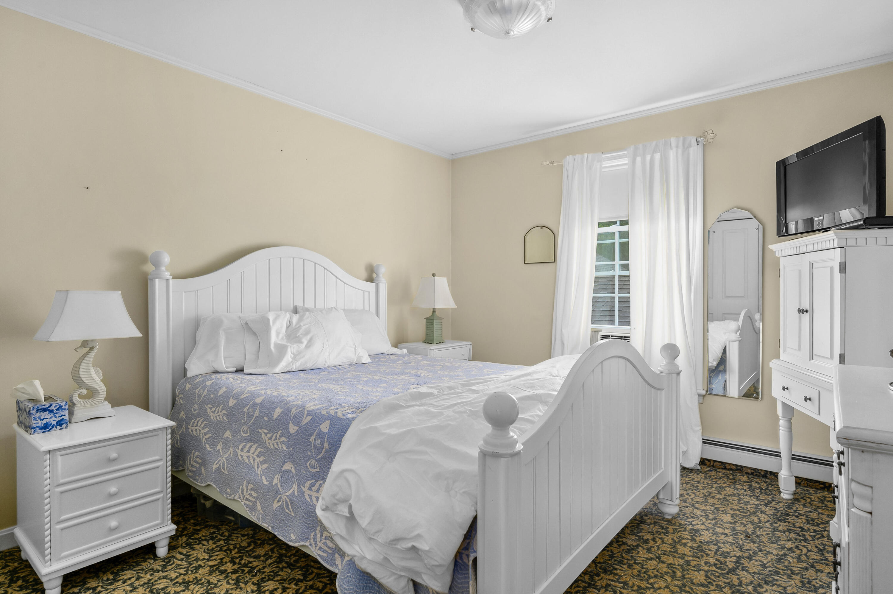 256 Pleasant Bay Road Harwich, MA 02645 - Photo 33 of 71 a bedroom with a bed and a flat screen tv