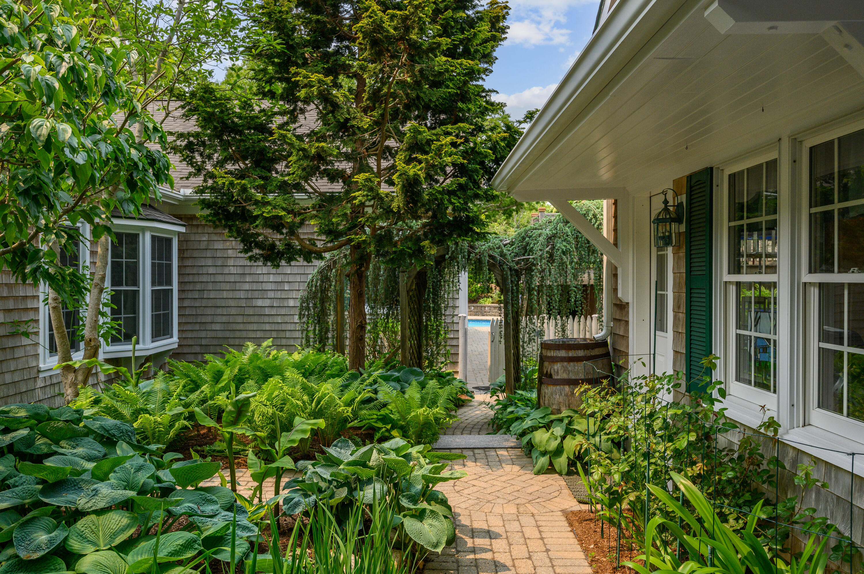 256 Pleasant Bay Road Harwich, MA 02645 - Photo 4 of 71 a front view of a house with a garden