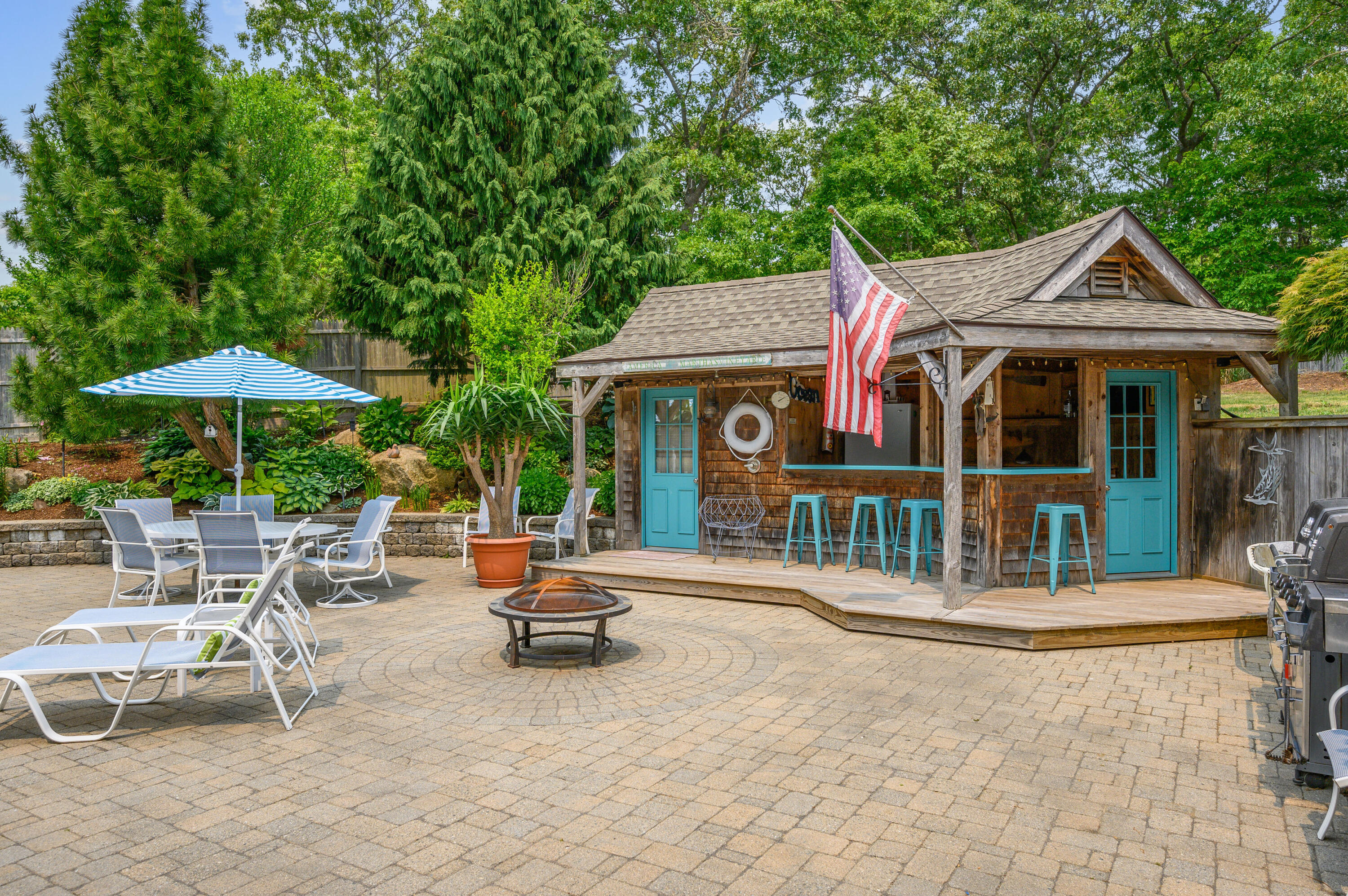 256 Pleasant Bay Road Harwich, MA 02645 - Photo 46 of 71 a front view of a house with garden and sitting area