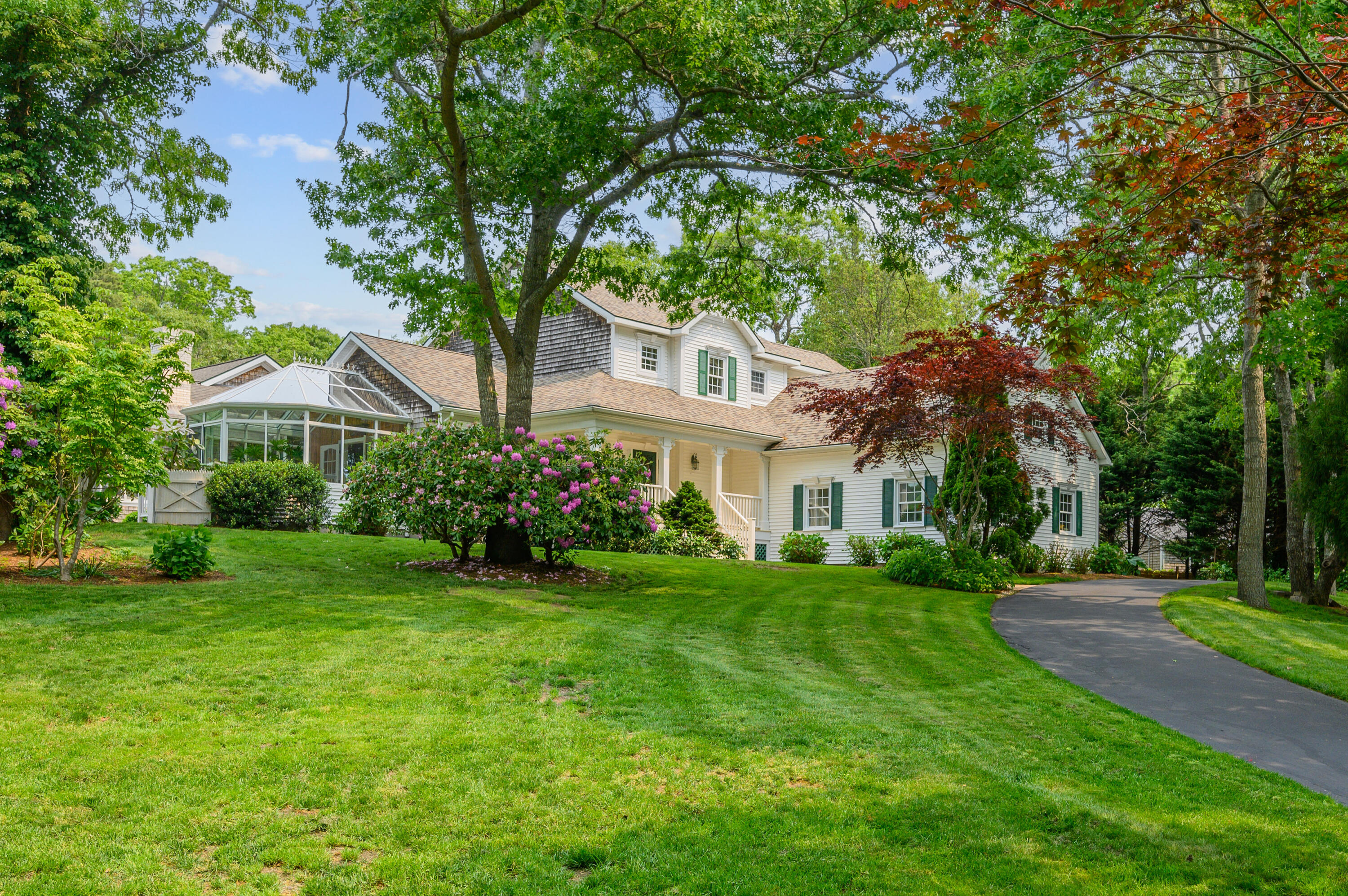 256 Pleasant Bay Road Harwich, MA 02645 - Photo 59 of 71 a front view of a house with a yard and trees
