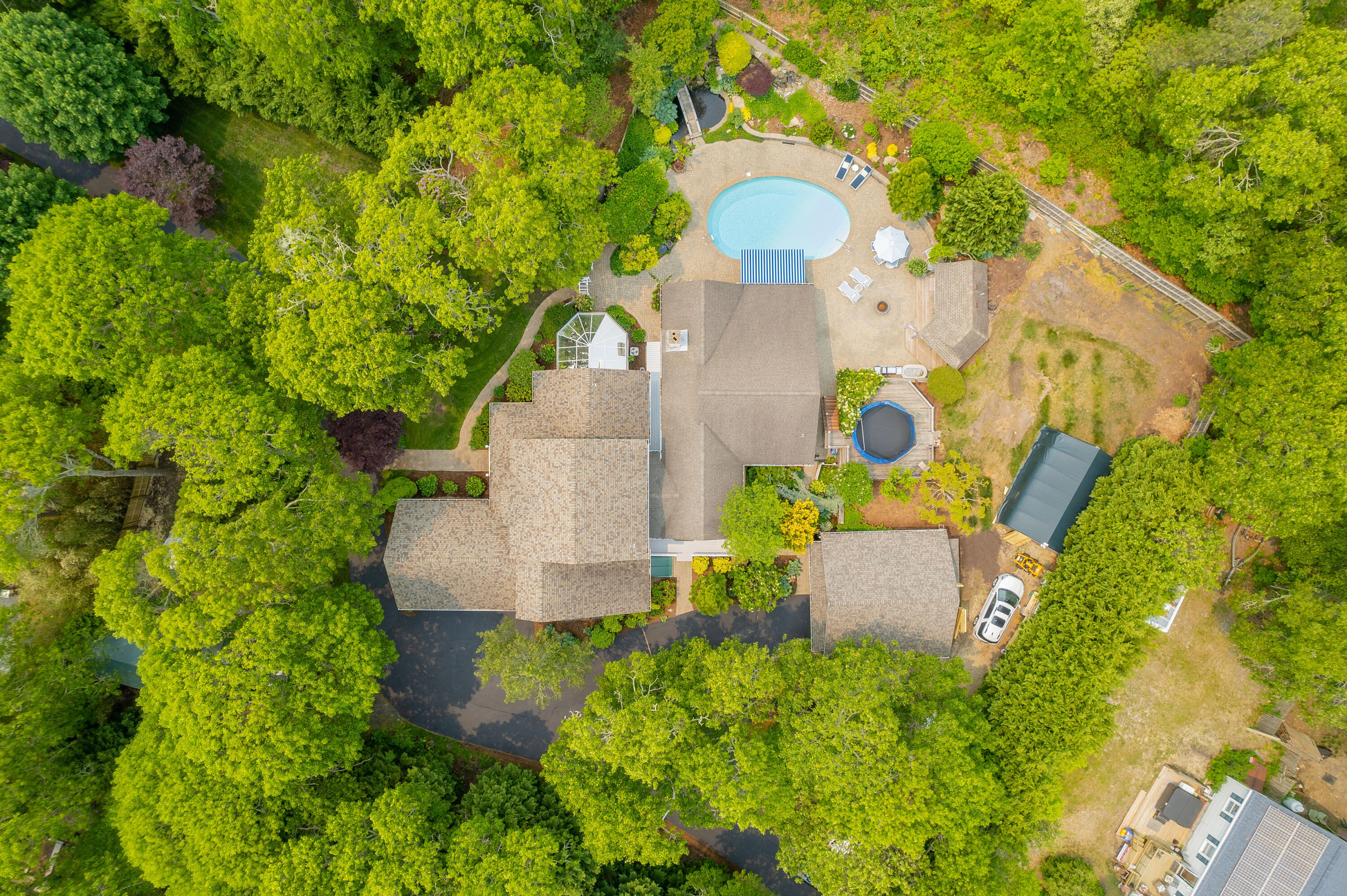256 Pleasant Bay Road Harwich, MA 02645 - Photo 63 of 71 an aerial view of a house with a yard and trees all around
