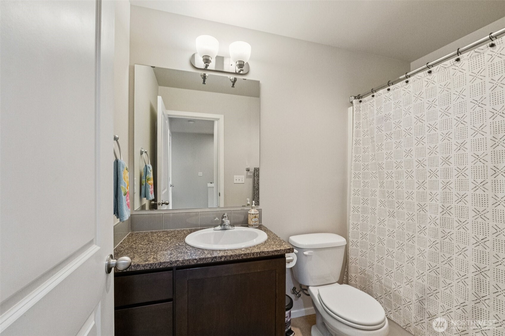 16408 2nd Avenue Southeast Bothell, WA 98012 - Photo 19 of 27 a bathroom with a granite countertop sink toilet a mirror and shower curtain