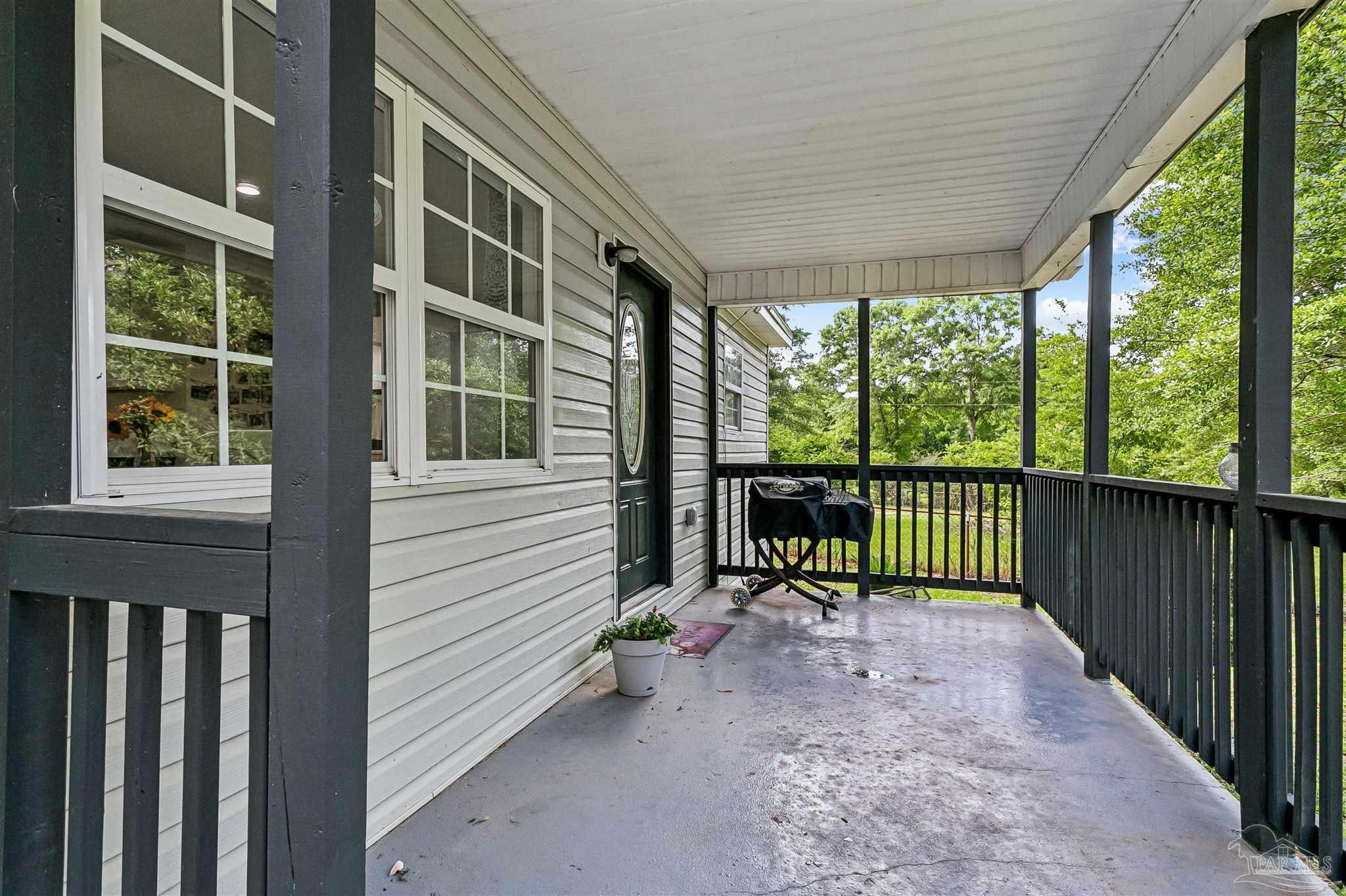 1095 River Annex Road Cantonment, FL 32533 - Photo 4 of 32 a view of a porch with a floor to ceiling window