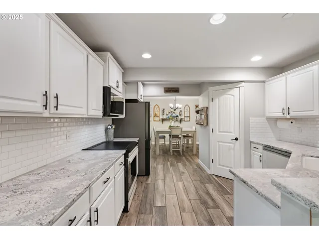 a kitchen with refrigerator and cabinets