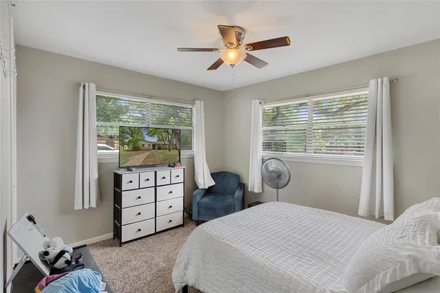 a bedroom with a large bed and a window