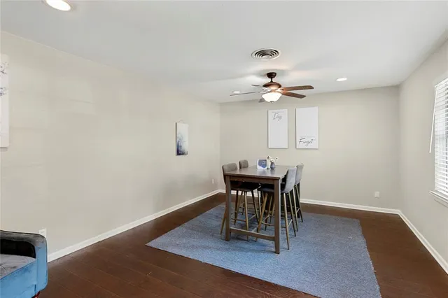 a view of a dining room with furniture and a chandelier