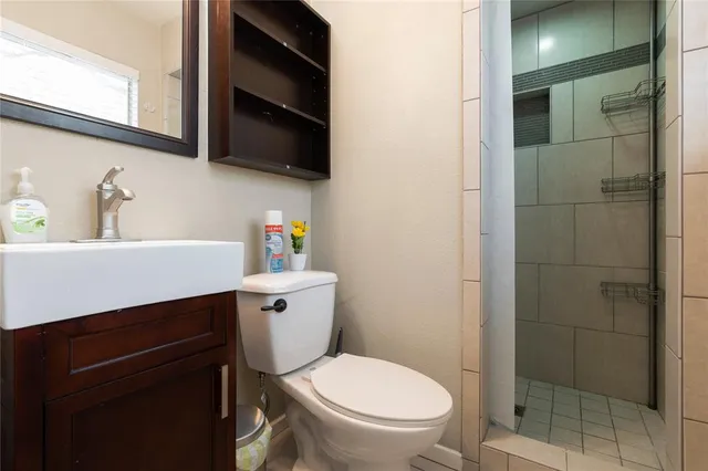 a bathroom with a toilet a sink and a window