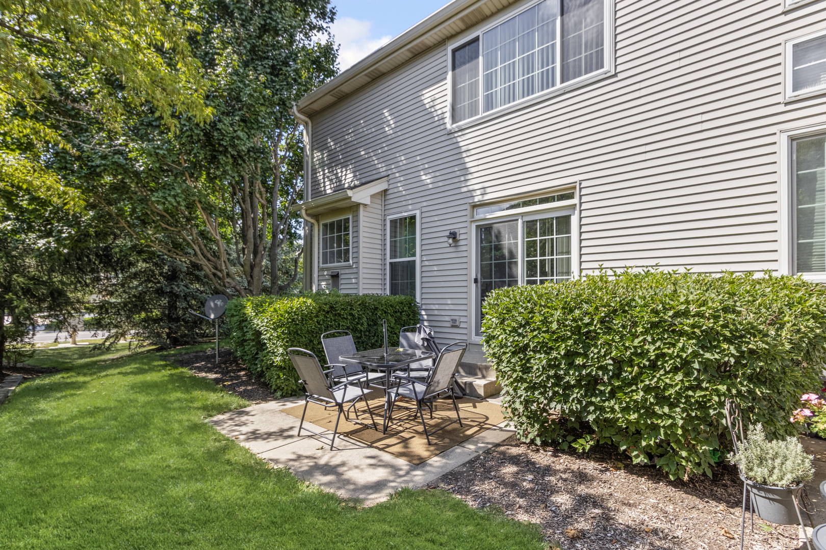 2451 Stonegate Road, Unit 2451 Algonquin, IL 60102 - Photo 3 of 20 a view of a chair and table in backyard of the house