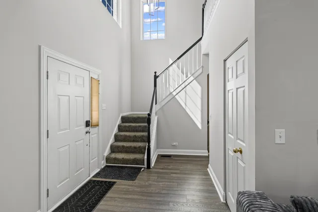 a view of a hallway with wooden floor and staircase