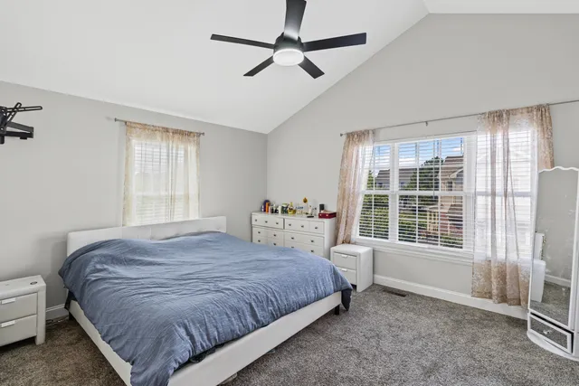 a bedroom with a bed dresser and a window