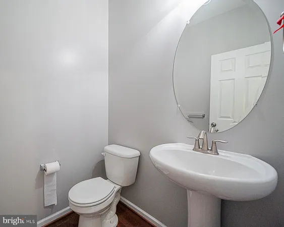 a bathroom with a sink toilet and a mirror
