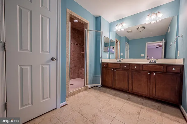 a spacious bathroom with a double vanity sink and a mirror