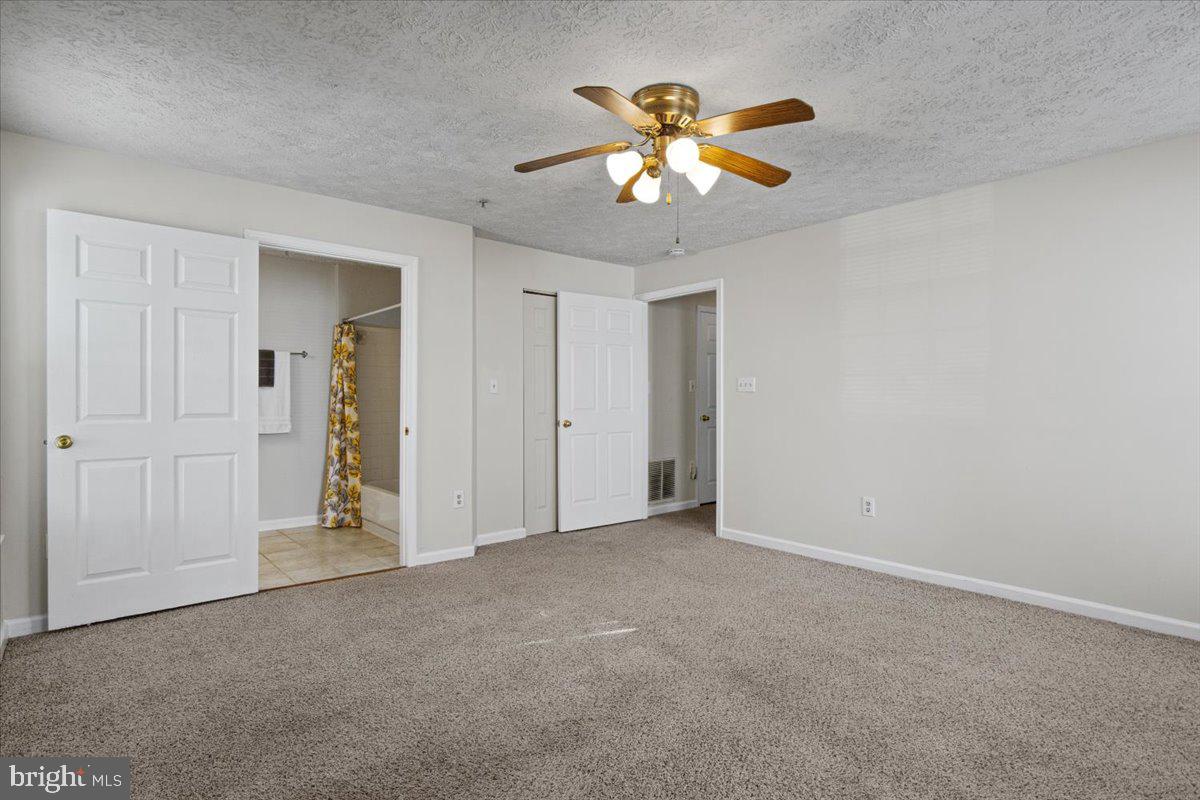 2445 Blue Spring Court, Unit 103 Odenton, MD 21113 - Photo 20 of 31 a view of an empty room with a chandelier fan