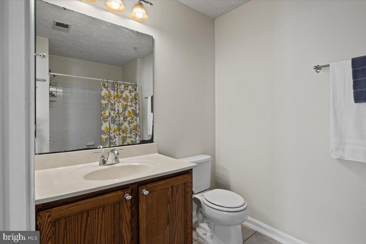 2445 Blue Spring Court, Unit 103 Odenton, MD 21113 - Photo 22 of 31 a bathroom with a sink and a toilet