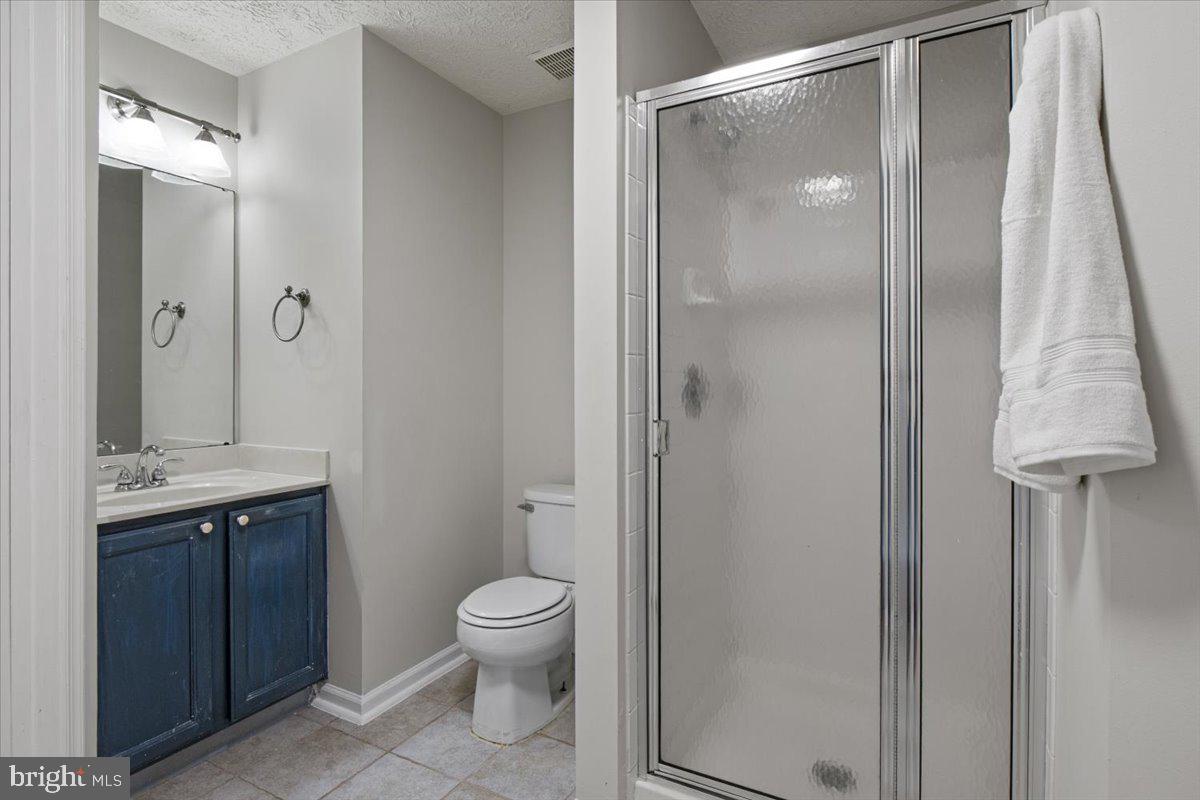 2445 Blue Spring Court, Unit 103 Odenton, MD 21113 - Photo 24 of 31 a bathroom with a toilet a sink and shower