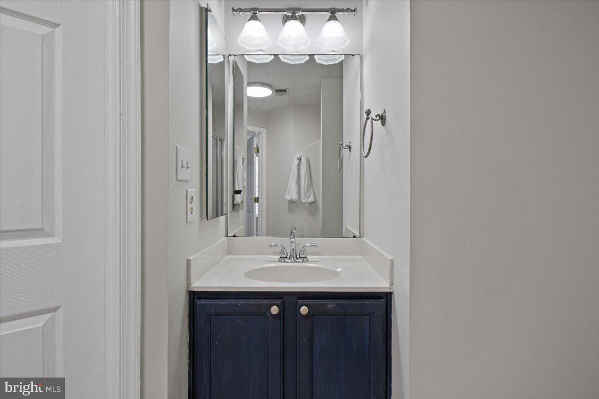 2445 Blue Spring Court, Unit 103 Odenton, MD 21113 - Photo 25 of 31 a bathroom with a sink and a mirror
