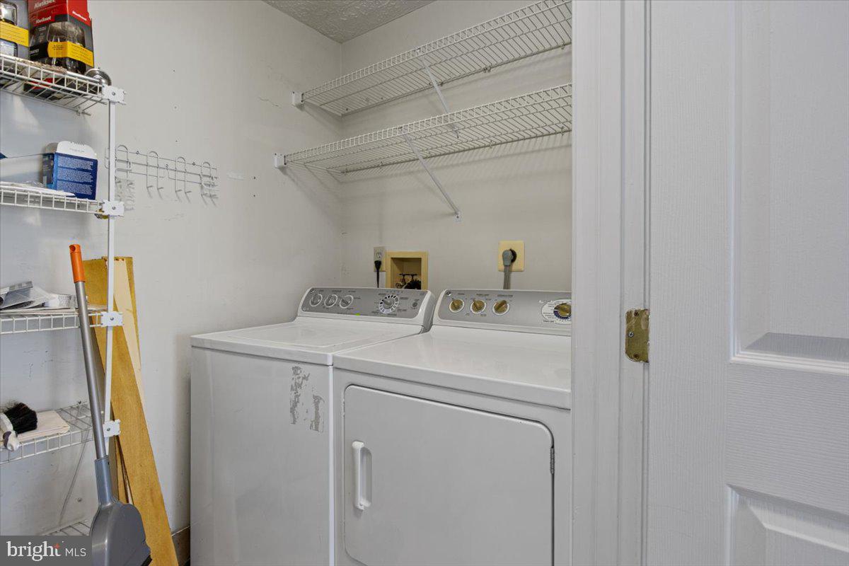 2445 Blue Spring Court, Unit 103 Odenton, MD 21113 - Photo 29 of 31 a utility room with dryer and washer