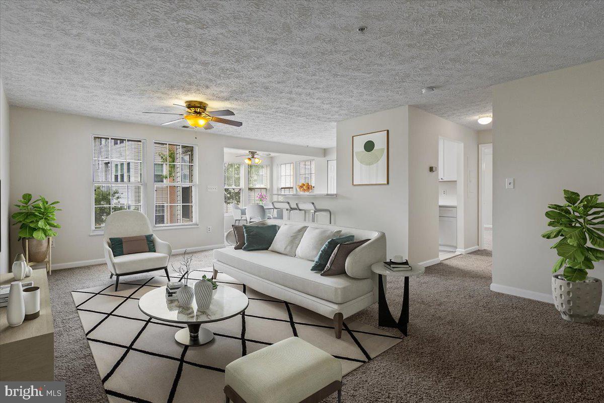 2445 Blue Spring Court, Unit 103 Odenton, MD 21113 - Photo 5 of 31 a living room with furniture and wooden floor