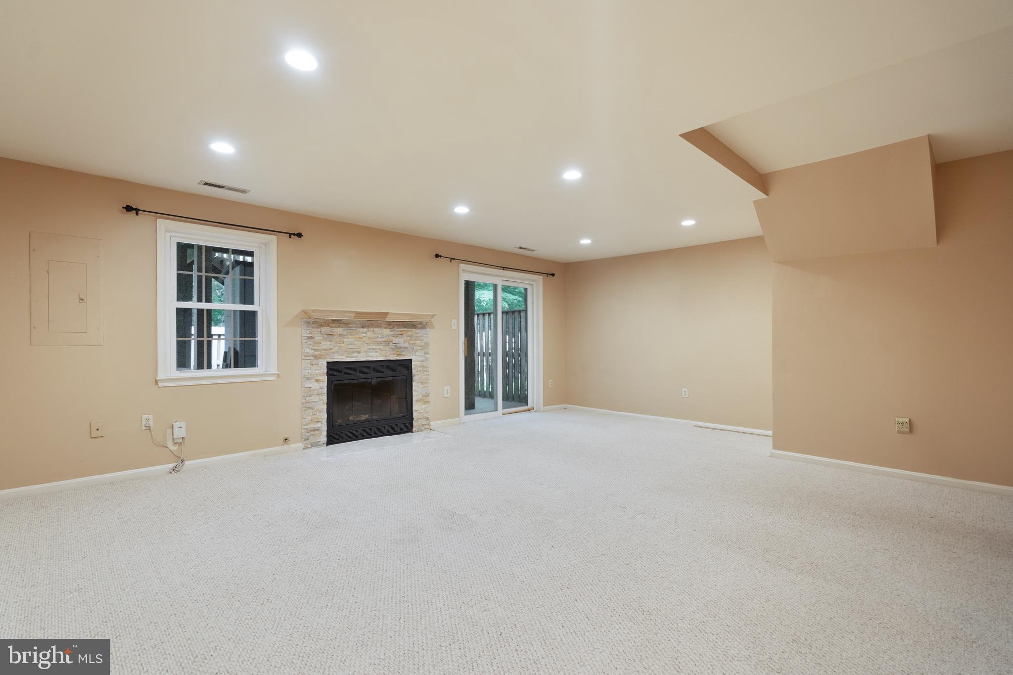 7314 Spring View Court Springfield, VA 22153 - Photo 20 of 23 Rec room with gas fireplace and lower deck access.