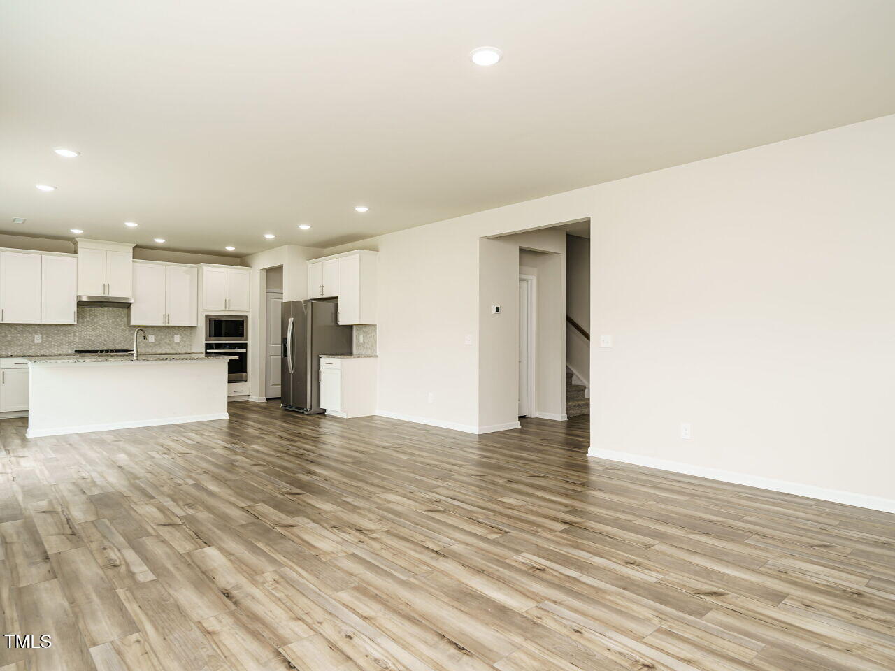 792 Riguard Way Wendell, NC 27591 - Photo 14 of 46 a view of kitchen with kitchen island wooden floor center island and stainless steel appliances