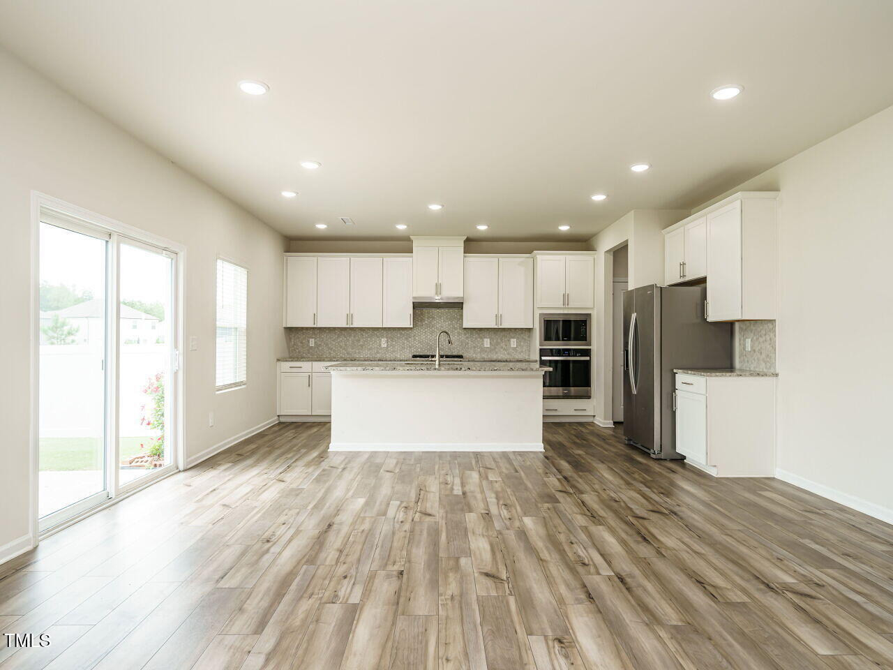 792 Riguard Way Wendell, NC 27591 - Photo 15 of 46 a large kitchen with stainless steel appliances kitchen island a large counter top and a refrigerator