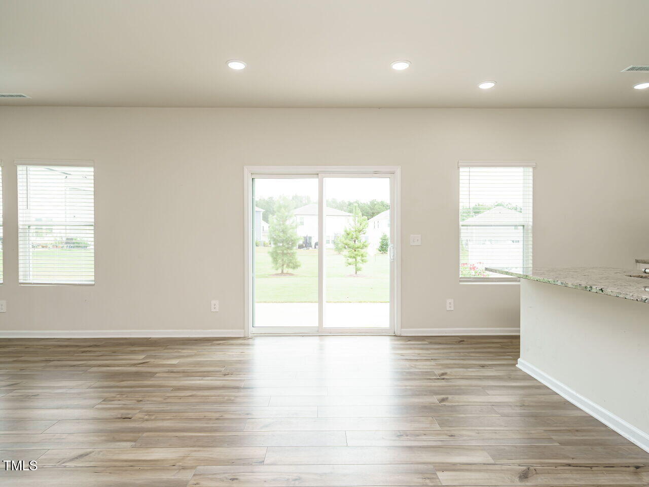 792 Riguard Way Wendell, NC 27591 - Photo 16 of 46 an empty room with wooden floor and windows